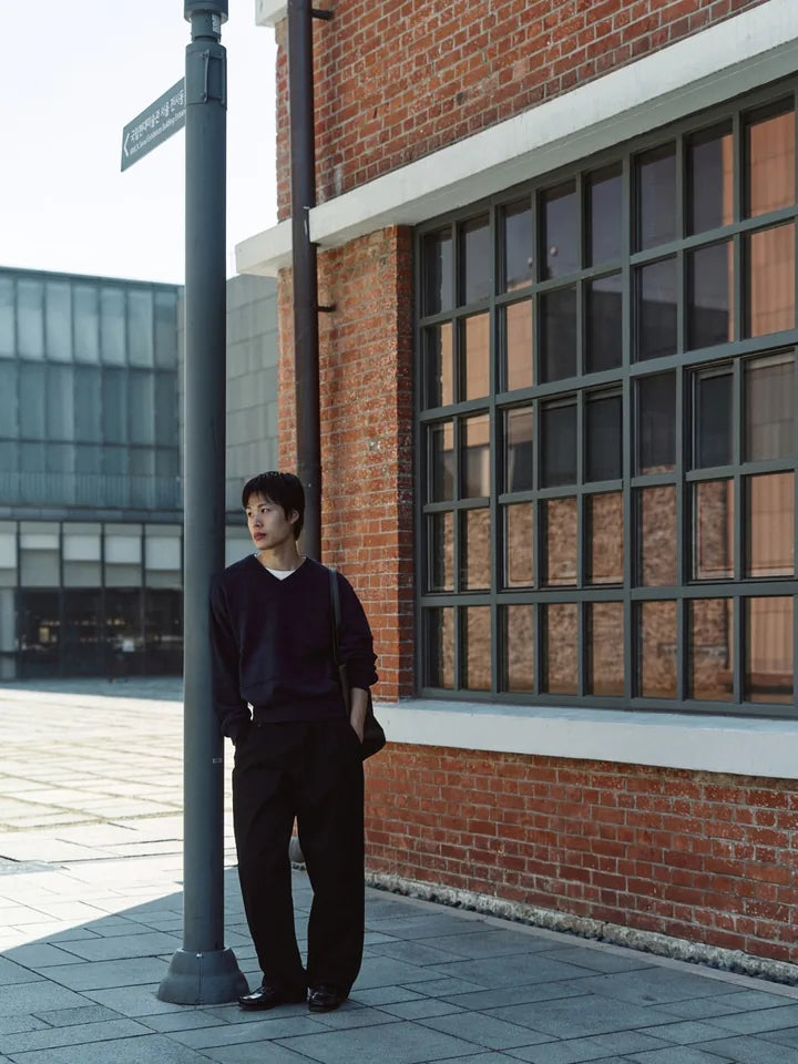 

A navy V-neck and black chinos on a clear afternoon — 1